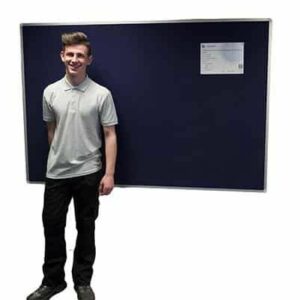 man stood in front of a dark blue noticeboard