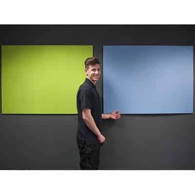 man stood in front of green and blue notice boards